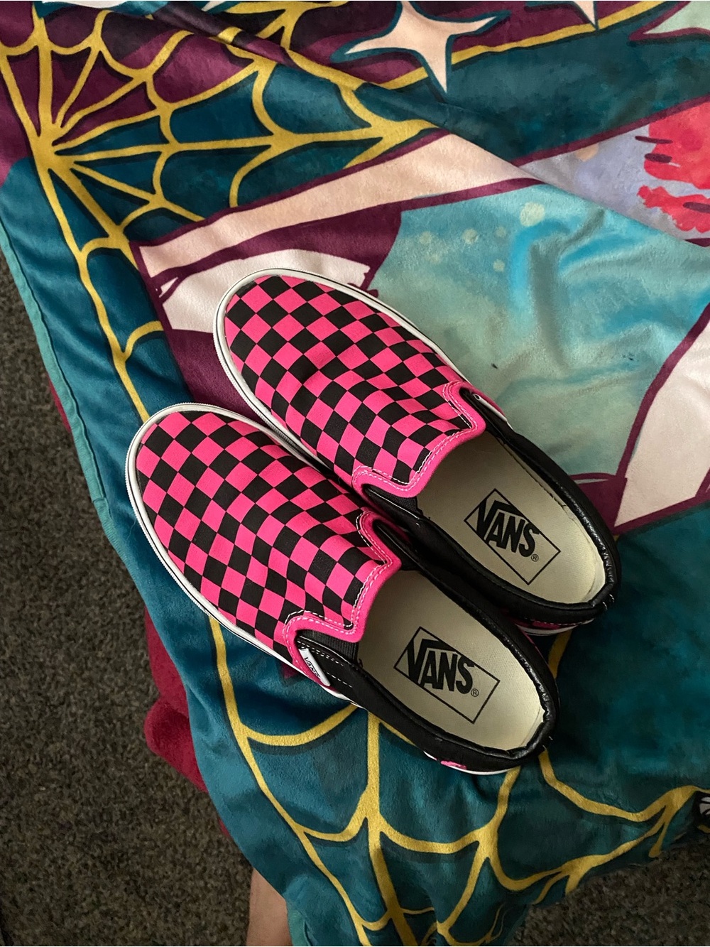 Pink and black checkerboard slip on vans